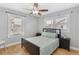 Charming bedroom with hardwood floors, a queen-size bed, and plenty of natural light at 1454 Rosemary St, Denver, CO 80220