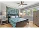 Bright bedroom with hardwood floors, featuring a queen-size bed and ample closet space at 1454 Rosemary St, Denver, CO 80220