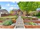 Brick home with landscaped yard and walkway at 1454 Rosemary St, Denver, CO 80220