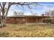 Back of house with brick exterior and patio at 1540 S Kendall St, Lakewood, CO 80232