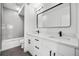 Modern bathroom with double vanity, white cabinets, and quartz countertop at 1414 Pierce St, Lakewood, CO 80214