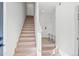 Bright entryway with light wood stairs and built-in bench seating at 1414 Pierce St, Lakewood, CO 80214