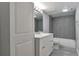 Modern bathroom with gray tile and white vanity at 9995 E Harvard Ave # 179, Denver, CO 80231