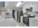 Updated kitchen featuring stainless steel appliances and white cabinetry at 9995 E Harvard Ave # 179, Denver, CO 80231