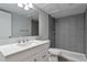 Updated bathroom with gray tile shower and white vanity at 9995 E Harvard Ave # 179, Denver, CO 80231
