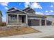 Two-story house with gray siding, two-car garage, and front porch at 4277 Canyata Dr, Elizabeth, CO 80107