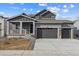 Two-story house with gray siding, two-car garage, and front porch at 4277 Canyata Dr, Elizabeth, CO 80107