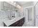 Modern bathroom with double vanity, quartz countertop, and shower at 5524 Uinta St, Denver, CO 80238