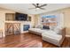 Living room with L-shaped sofa, fireplace and hardwood floors at 10532 Joplin St, Commerce City, CO 80022