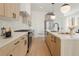 Modern kitchen with light wood cabinets, quartz countertops, and stainless steel appliances at 1417 Zenobia St, Denver, CO 80204