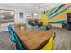 Long wooden dining table with teal and yellow chairs at 951 S Fulton St, Aurora, CO 80247