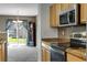 Bright kitchen with granite counters, stainless steel appliances, and backyard access at 1160 Cardinal Ave, Brighton, CO 80601