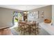 Dining area with hardwood floors, a chandelier, and sliding glass doors leading to the backyard at 1160 Cardinal Ave, Brighton, CO 80601