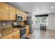 Kitchen boasts granite countertops and modern appliances at 1160 Cardinal Ave, Brighton, CO 80601