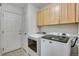 Laundry room with washer, dryer, and upper cabinets at 1160 Cardinal Ave, Brighton, CO 80601