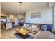 Open living space with L-shaped couch and kitchen view at 10176 Park Meadows Dr # 2406, Lone Tree, CO 80124