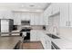 Modern kitchen with white cabinets, quartz countertops, and stainless steel appliances at 1181 S Navajo St, Denver, CO 80223