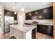 Well-equipped kitchen with dark cabinets, stainless steel appliances, and a center island at 5059 Fawn Ridge Way, Castle Rock, CO 80104