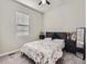 Bright bedroom with carpeted floor, a queen-size bed, and a large window at 16025 Stringhalt Way, Parker, CO 80134