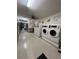 Shared laundry room with multiple washers and dryers at 650 S Clinton St # 5B, Denver, CO 80247