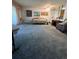 Open living room with a built-in bed and carpeted floor at 650 S Clinton St # 5B, Denver, CO 80247