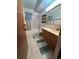 Bathroom with tub shower, toilet and wood vanity at 650 S Clinton St # 5B, Denver, CO 80247