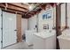 Basement laundry area with washer, dryer, and utility sink at 6335 Martin Luther King Jr Blvd, Denver, CO 80207