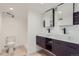 Modern basement bathroom with double vanity and updated fixtures at 6335 Martin Luther King Jr Blvd, Denver, CO 80207