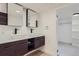 Basement bathroom featuring double vanity and large mirrors at 6335 Martin Luther King Jr Blvd, Denver, CO 80207