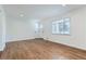 Bright living room featuring hardwood floors and fresh paint at 6335 Martin Luther King Jr Blvd, Denver, CO 80207