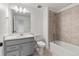 Clean bathroom with a gray vanity, bathtub, and shower at 9314 Quartz St, Arvada, CO 80007