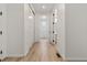 Bright hallway with light wood flooring and access to rooms at 9314 Quartz St, Arvada, CO 80007