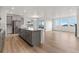 Modern kitchen with gray cabinets, island, and stainless steel appliances at 9314 Quartz St, Arvada, CO 80007