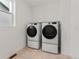 Laundry room with washer, dryer, and overhead shelving at 9314 Quartz St, Arvada, CO 80007