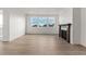 Bright living room with hardwood floors, fireplace, and large windows at 9314 Quartz St, Arvada, CO 80007