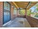 Brick front porch with ornate metal door and small planter at 5038 W 29Th Ave, Denver, CO 80212