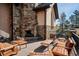 Stone fireplace and seating area on patio at 8830 Witez Ct, Parker, CO 80134