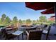 Round fire pit with seating overlooking golf course at 8830 Witez Ct, Parker, CO 80134