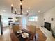 Bright dining room with hardwood floors and a modern chandelier at 5126 Johnson St, Arvada, CO 80002