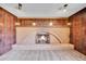 Basement room with brick fireplace, wood-paneled walls and carpet at 11326 E Berry Dr, Englewood, CO 80111