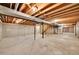 Unfinished basement with concrete floors and wooden beam ceiling at 11326 E Berry Dr, Englewood, CO 80111