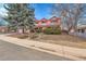 Front yard of a two-story brick house with a landscaped yard and driveway at 11326 E Berry Dr, Englewood, CO 80111