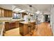 Kitchen with island, granite countertops, wood cabinets at 11326 E Berry Dr, Englewood, CO 80111