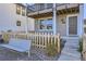 Townhome front porch with dark gray door and white columns at 128 E Douglas St, Superior, CO 80027