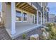 Ground level patio, gray exterior, white columns, small yard at 128 E Douglas St, Superior, CO 80027