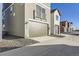 Three-story home with a two-car garage, light tan siding, and a balcony at 128 E Douglas St, Superior, CO 80027