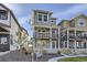 Two-story townhome with gray exterior, white trim, and picket fence at 128 E Douglas St, Superior, CO 80027