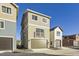 Tan three-story home with a two-car garage and balcony at 128 E Douglas St, Superior, CO 80027