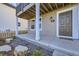Ground level patio, gray exterior, white columns, small yard at 128 E Douglas St, Superior, CO 80027
