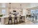 Open concept kitchen with an island, stainless steel appliances, and white quartz countertops at 128 E Douglas St, Superior, CO 80027